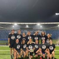 Students wearing championship shirts from a coed soccer tournament